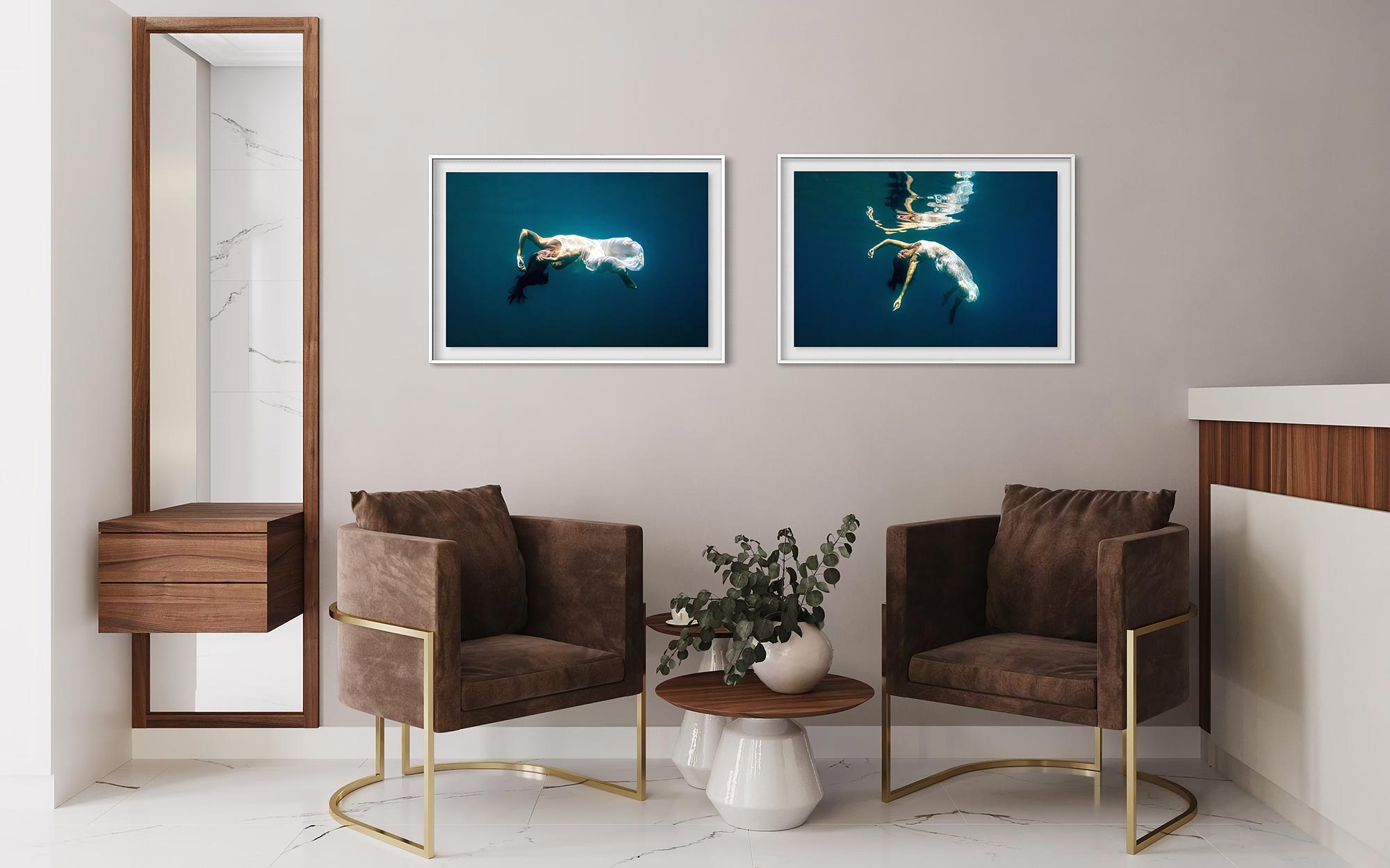 A diptych of Fine art underwater portrait prints showing a woman floating in deep blue water, displayed as a framed artwork in a modern waiting room above to soft chairs.