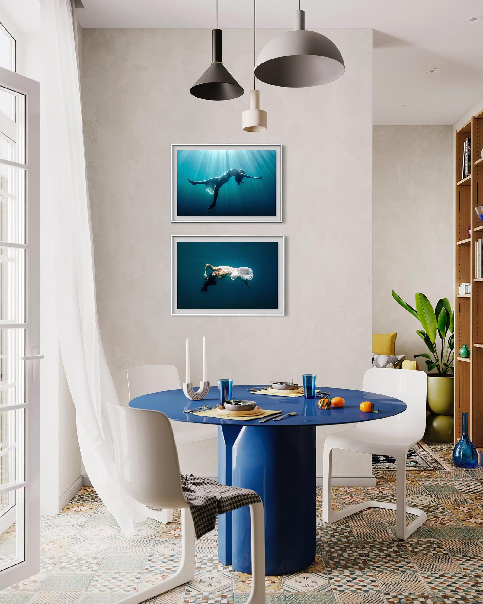 Two underwater fine art photographs styled as wall art one above another in a simple modern kitchen interior.